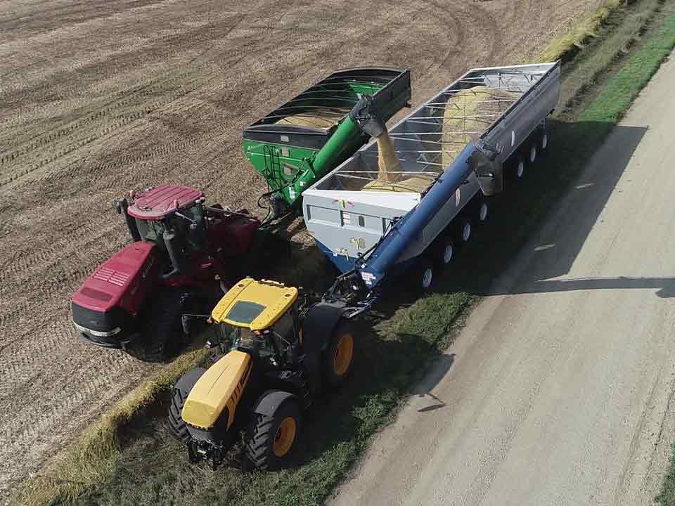 A mother bin grain cart being loaded with grain during harvest.